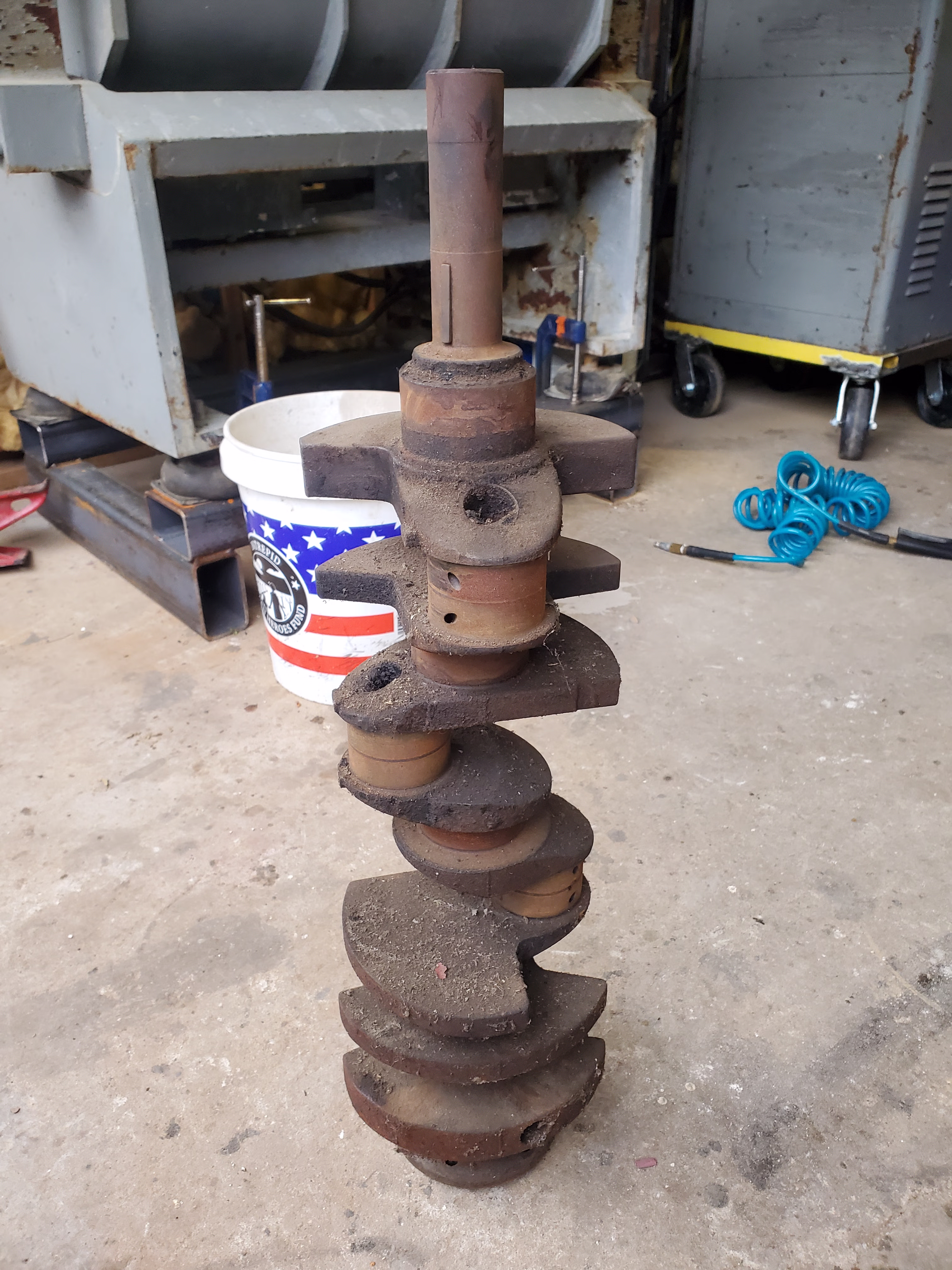 Before image of engine crank being prepped for vibratory cleaning/polishing.