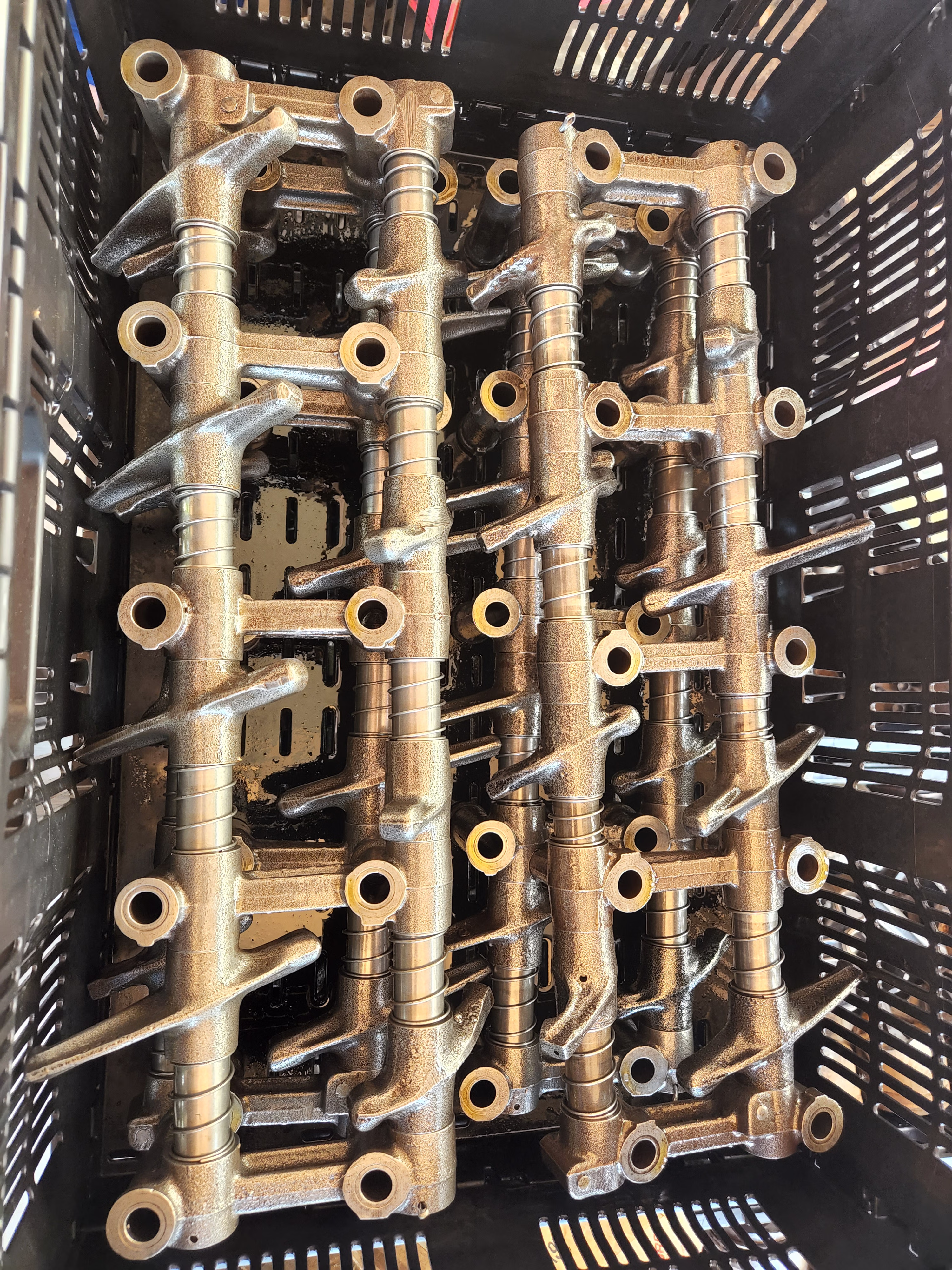 After view of vibratory cleaning process on hemi rocker arms.